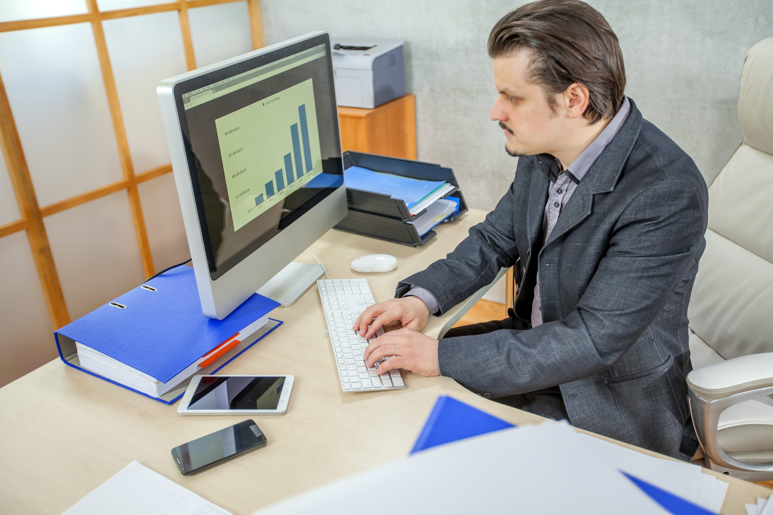 A young businessman working from his office - the concept of hard work