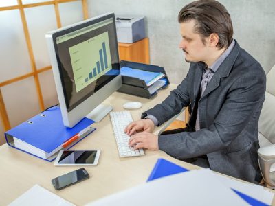 A young businessman working from his office  - the concept of hard work